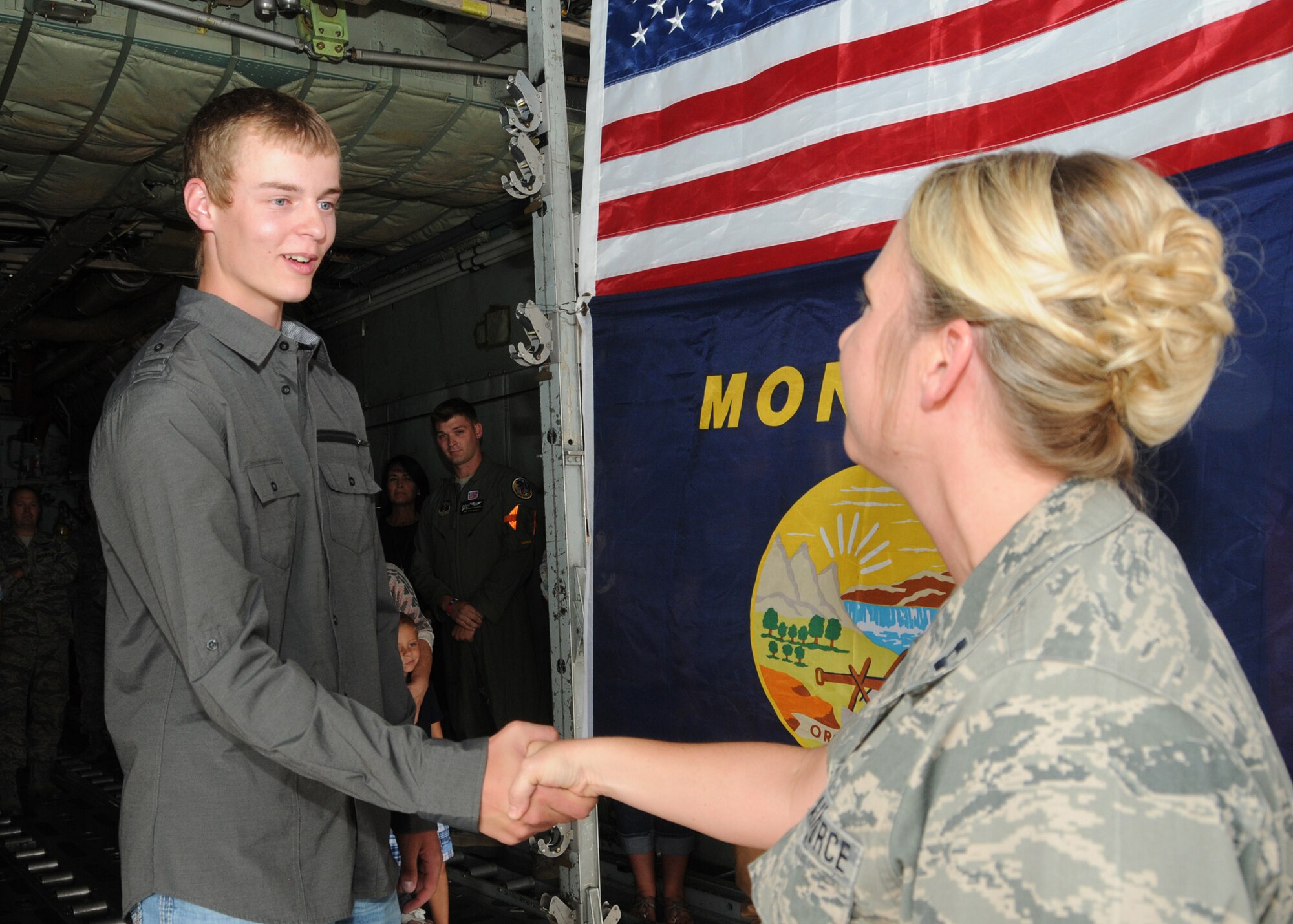 Tyler LaPierre is congratulated by Capt. Jennifer LaPierre Gunter following his Montana Air National Guard enlistment in the cargo hold of a C-130 Hercules transport aircraft parked at the 120th Airlift Wing in Great Falls, Mont. Aug. 31, 2016. Gunter administered LaPierre’s oath of enlistment. (U.S. Air National Guard photo by Senior Master Sgt. Eric Peterson)