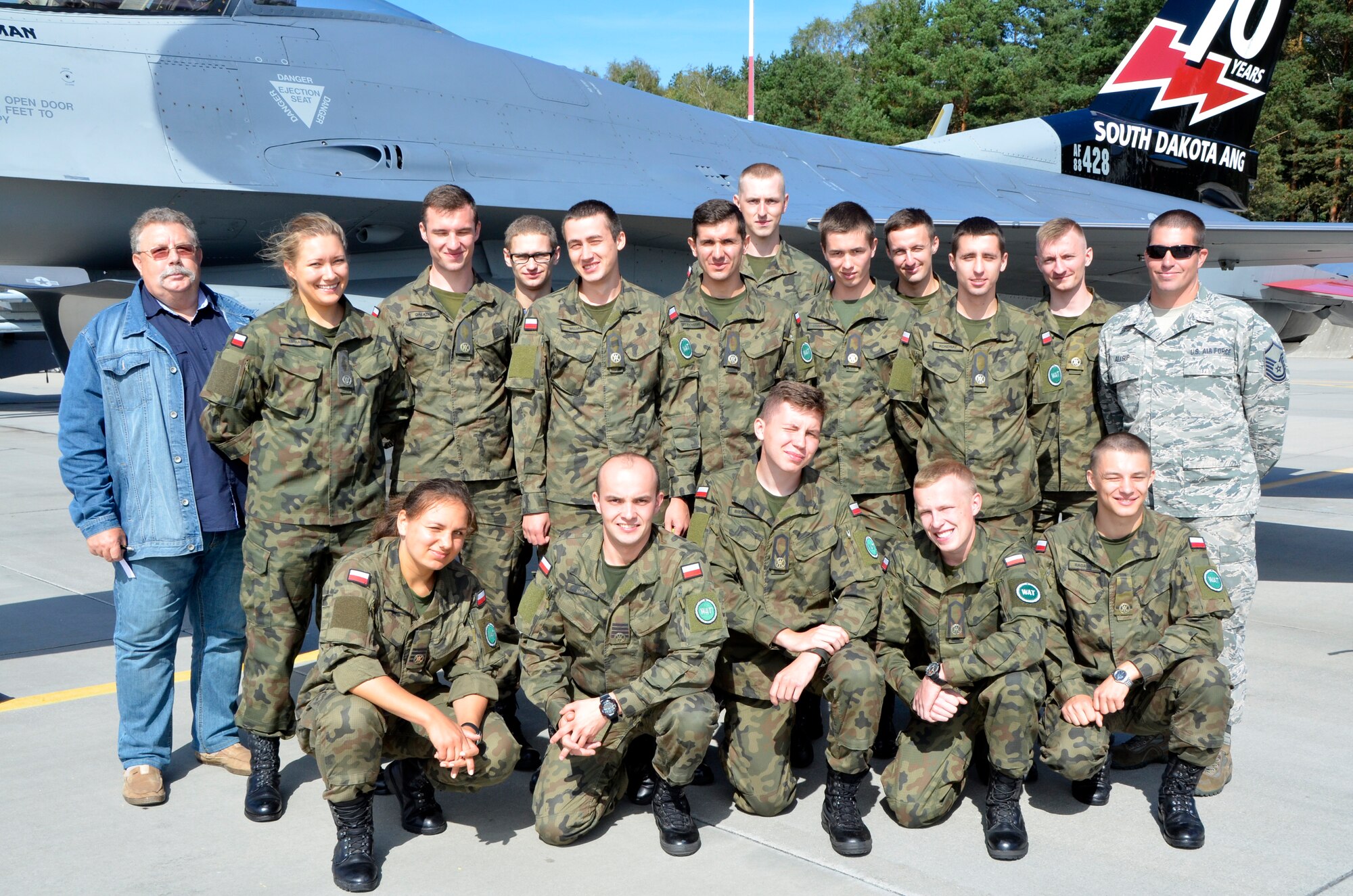 Lask Air Base, Poland - Polish maintenance officer cadets stand in front of a 114th Fighter Wing F-16 Fighting Falcon here, Sept. 6. The cadets had the opportunity to visit with 114th Maintenance Group personnel and learn about the similarities and differences between the 114th MXG and Polish maintenance. (U.S. Air National Guard photo by Capt. Amy Rittberger/Released)