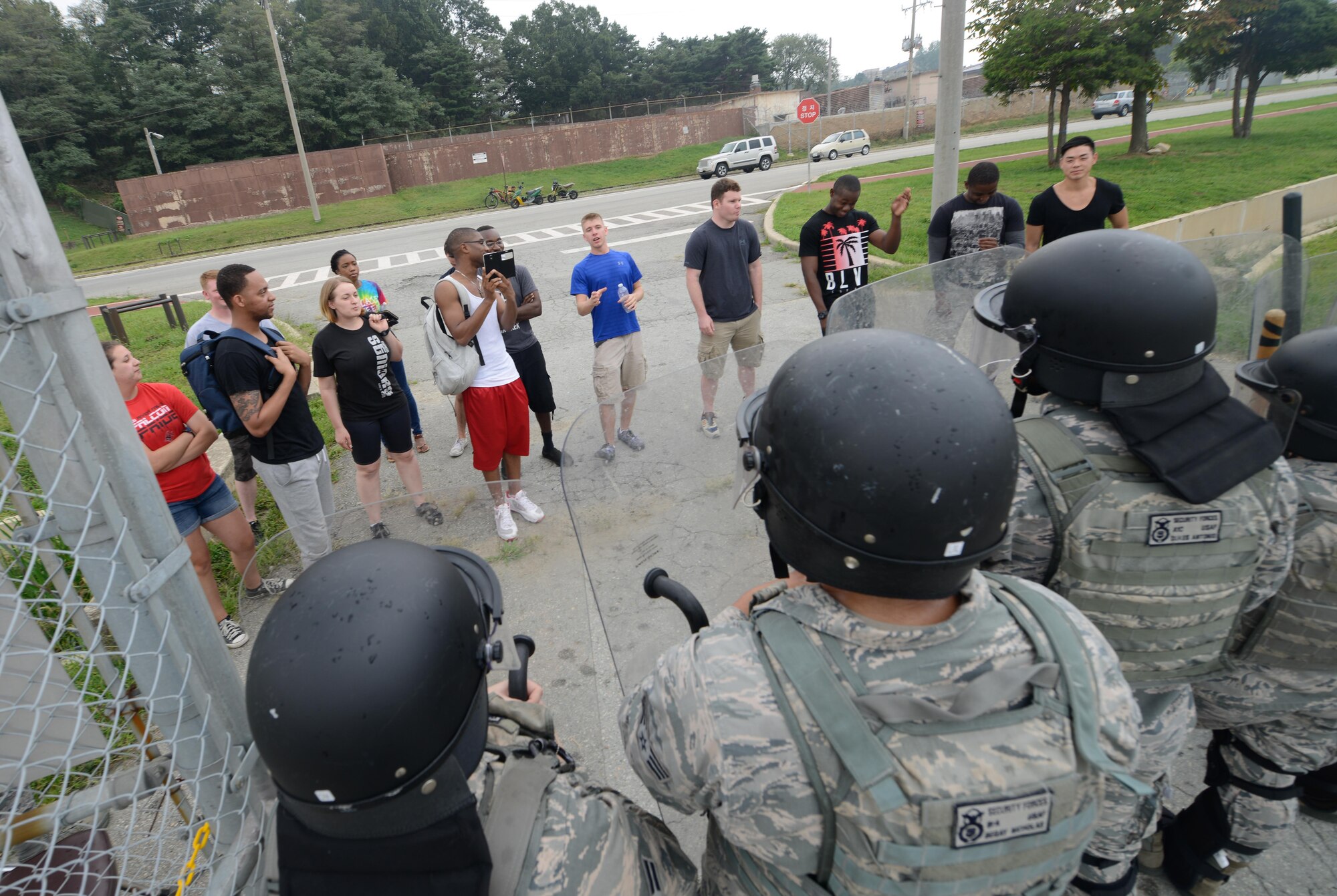 Defenders from the 51st Security Forces Squadron guard the flightline from simulated media personnel during an emergency management exercise at Osan Air Base, Republic of Korea, Sept. 8, 2016. The exercise prepared 51st Fighter Wing personnel to effectively respond to aircraft crashes during an air show. (U.S. Air Force photo by Senior Airman Dillian Bamman)