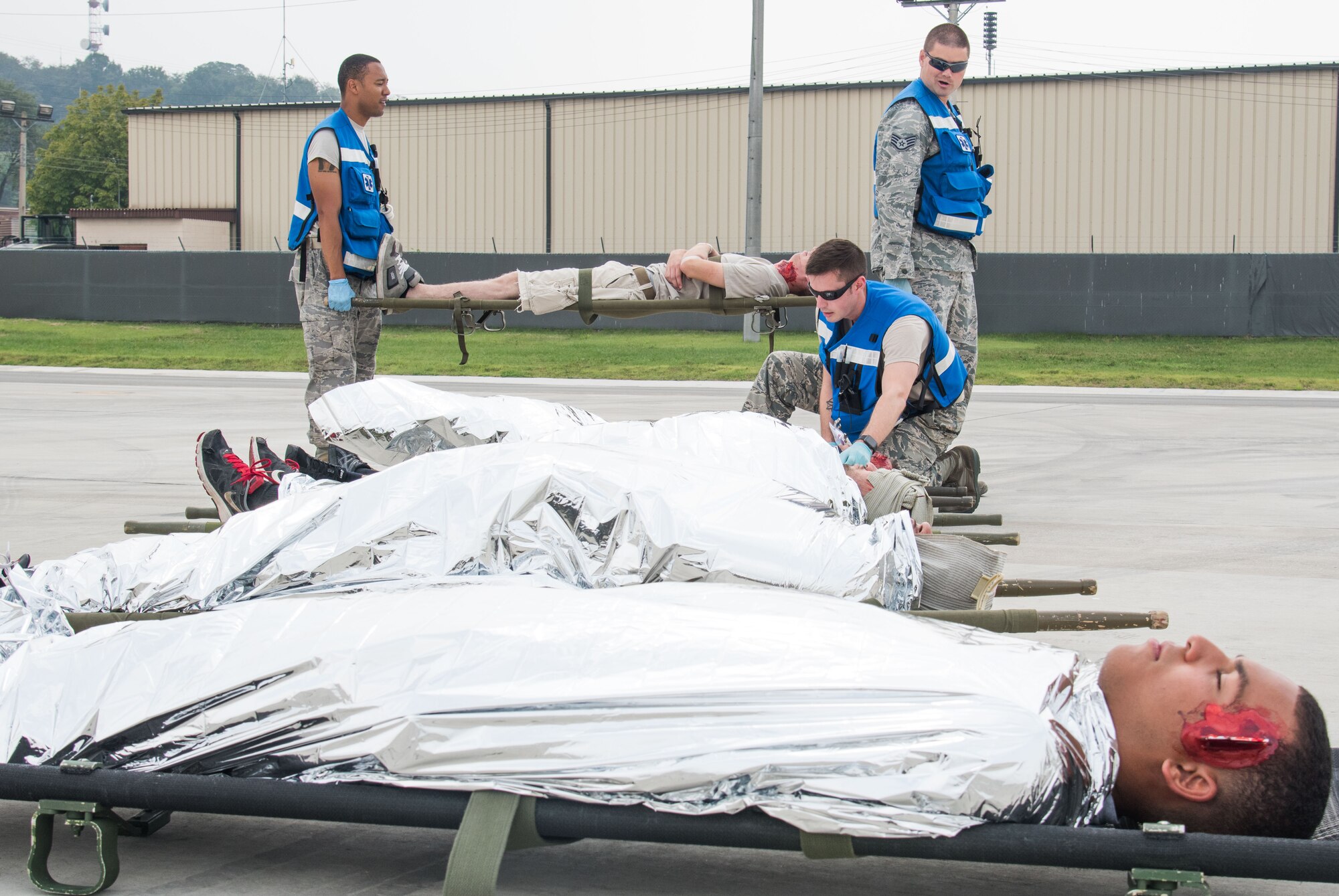 U.S. Airmen from the 51st Medical Group line up simulated injured individuals during an emergency management exercise at Osan Air Base, Republic of Korea, Sept. 8, 2016. Airmen from the 51st Fighter Wing practiced emergency management procedures in case of situations with downed aircraft. (U.S. Air Force photo by Senior Airman Dillian Bamman)