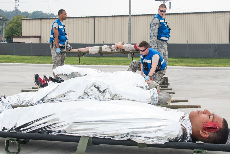 U.S. Airmen from the 51st Medical Group line up simulated injured individuals during an emergency management exercise at Osan Air Base, Republic of Korea, Sept. 8, 2016. Airmen from the 51st Fighter Wing practiced emergency management procedures in case of situations with downed aircraft. (U.S. Air Force photo by Senior Airman Dillian Bamman)