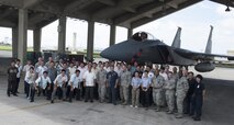 Members of the Kadena Police Station, Okinawa Police Station and Kadena’s 18th Security Forces Squadron stand in front of an F-15 Eagle Sept. 2, 2016, at Kadena Air Base, Japan. The 18th SFS hosted an open house event for local police officers. Part of this event included an opportunity to look at Kadena’s assets. (U.S. Air Force photo by Senior Airman Lynette M. Rolen)