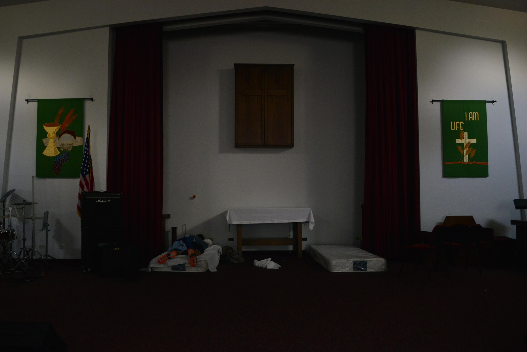 A U.S. Airman sleeps at the base chapel July 21, 2016, at Incirlik Air Base, Turkey. The chapel team secured and set-up more than 80 mattresses around the chapel for Airmen to sleep on during the base power outage. (U.S. Air Force photo by Senior Airman John Nieves Camacho)