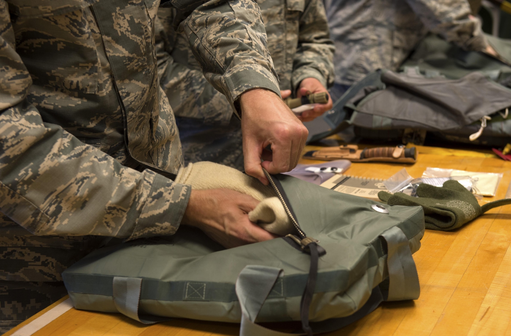 U.S. Air Force Chief Master Sgt. Edwin Ludwigsen, 52nd Fighter Wing command chief, learns how to pack an emergency survival bag during a Saber leadership “out and about” event at the parachute shop on Spangdahlem Air Base, Germany, Sept. 8, 2016. The event lets the 52nd FW commander and command chief get a hands on experience at Saber work centers in an effort to better understand the duties of Airmen at Spangdahlem. (U.S. Air Force photo by Airman 1st Class Preston Cherry/Released)