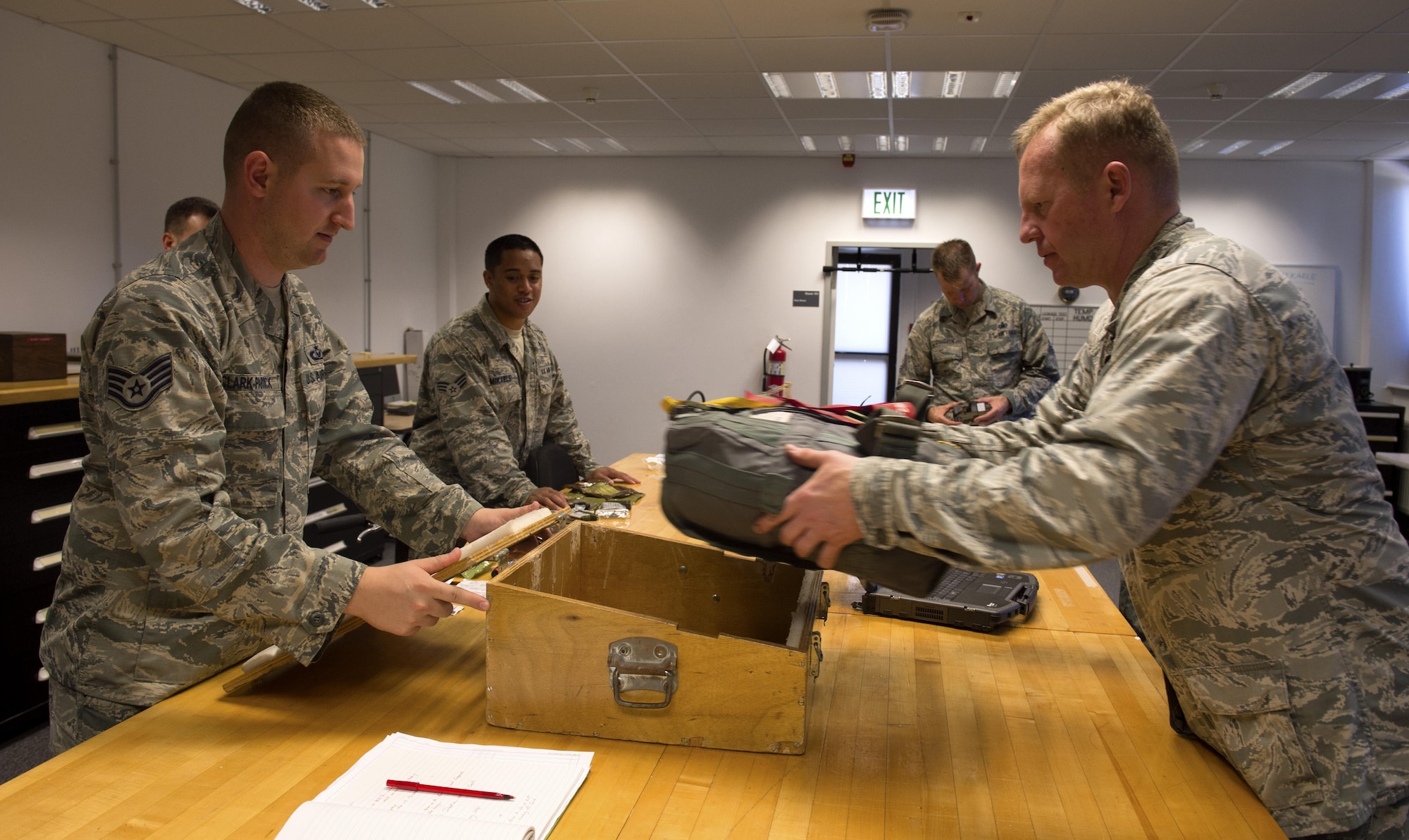 U.S. Air Force Staff Sgt. Joshua Clark-Parrick, 52nd Operations Support Squadron NCO in charge of aircrew flight operations main shop, left, helps Col. Joseph McFall, 52nd Fighter Wing commander, right, fit a survival bag into a F-16 Fighting Falcon simulated seat compartment during a Saber leadership “out and about” event at the parachute shop on Spangdahlem Air Base, Germany, Sept. 8, 2016. The event lets the 52nd FW commander and command chief get a hands on experience at Saber work centers in an effort to better understand the duties of Airmen at Spangdahlem. (U.S. Air Force photo by Airman 1st Class Preston Cherry/Released)
