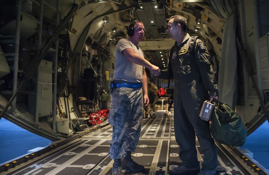 U.S. Air Force Col. Mark Barrera, 23d Wing vice commander, right, greets a 71st Rescue Squadron crew chief during Exercise Red Flag 16-4, Aug. 25, 2016, at Nellis Air Force Base, Nev. Barrera led the year’s fourth installment of the air-to-air combat training exercise as the acting Air Expeditionary Wing commander, where he implemented team-oriented tactics in a large, coalition force training environment. (U.S. Air Force photo by Airman 1st Class Kevin Tanenbaum)