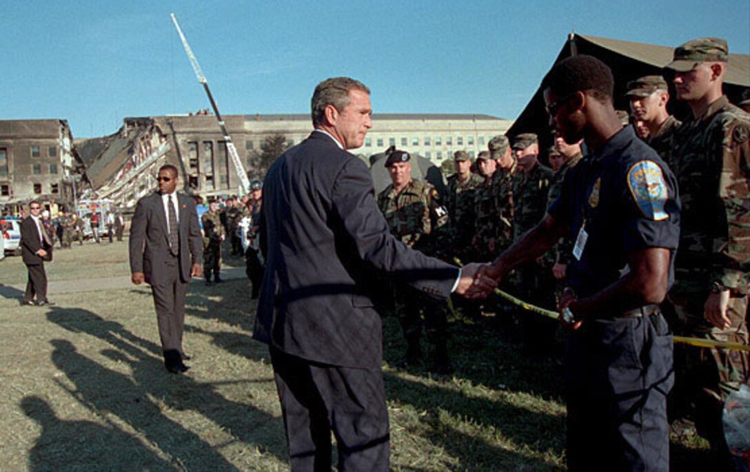 President George W. Bush thanks a first responder for his service following the 9/11 terrorist attack at the Pentagon, Sept. 12, 2001. Air Force photo by Jim Miller