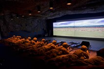 Defenders from the 91st Security Forces Group fire at the indoor U.S. Army training simulator at Camp Grafton Training Center, N.D., Sept. 7, 2016. Throughout August and September, various units within the 91st SFG completed combat capability assurance training at the Camp Grafton Training Center. (U.S. Air Force photo/Airman 1st Class J.T. Armstrong)