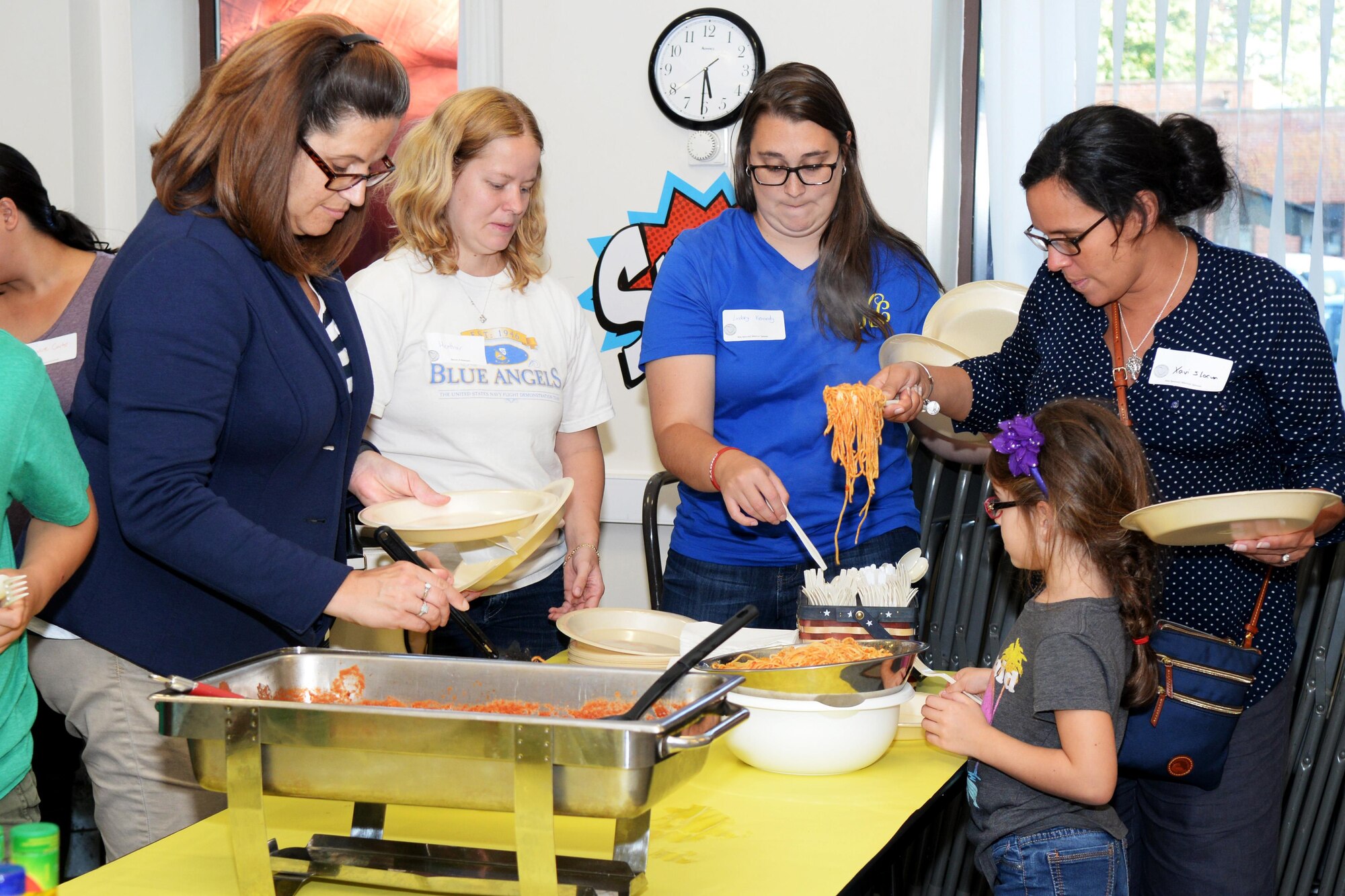 Team Mildenhall Airmen and spouses prepare their plates at a Hearts Apart event Sept. 8, 2016, on RAF Mildenhall. The monthly Hearts Apart dinners are a way for spouses and family members of deployed Airmen to gather together and connect. The dinner for this event was spaghetti and meatballs. (U.S. Air Force photo by Airman 1st Class Tenley Long)