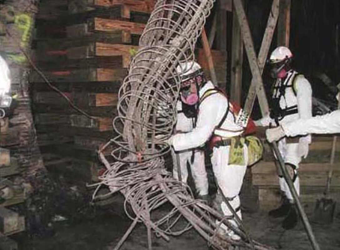 Workers remove a damaged building column as reconstruction begins in the Pentagon following the 9/11 terrorist attack. Navy photo