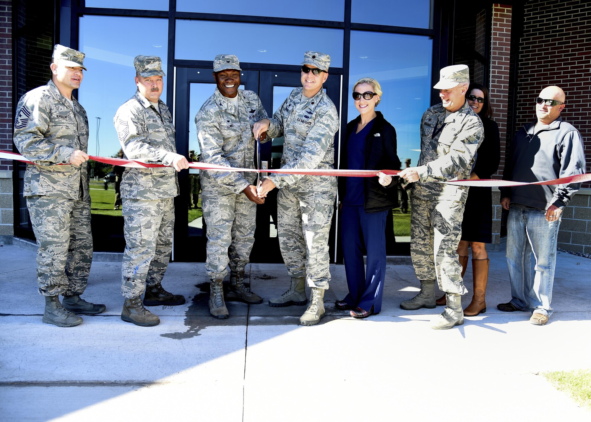 319th Air Base Wing leadership cut the ribbon on the newly-renovated 319th Communications Squadron headquarters building Sept. 8, 2016, on Grand Forks Air Force Base, N.D. The renovations updated the facilities to ensure the mission can be completed. (U.S. Air Force photo by Senior Airman Ryan Sparks/Released)