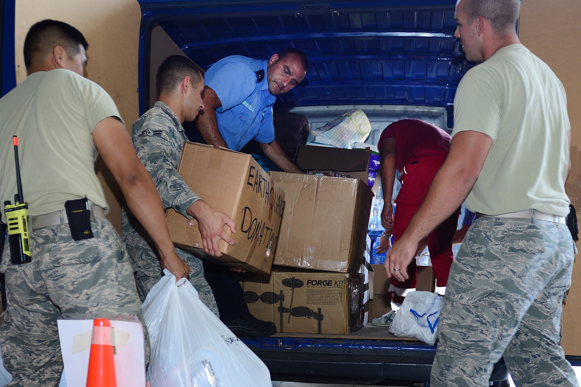 31st Civil Engineer Squadron firefighters hand care packages to Udine Red Cross on base, Sep. 8, 2016, in response for the central Italy earthquake. The earthquake happened on Aug. 24, 2016. The firefighters collected approximately 1,000 pounds of supplies ranging from diapers to hygiene items over a three-week period. (U.S. Air Force photo by Staff Sgt. Andrew M. Satran)