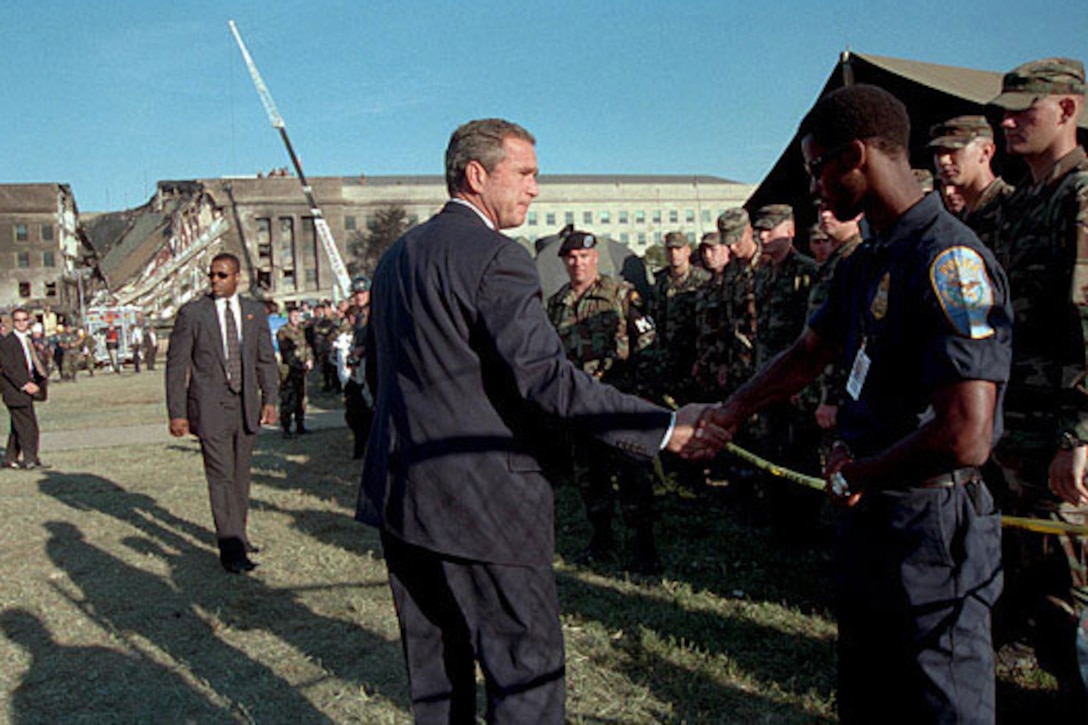 President George W. Bush thanks a first responder for his service outside the Pentagon on Sept. 12, 2001.