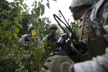 Lance Cpl. Timothy Blackburn (middle), Fleet Anti-Terrorism Support Team, Marine Corps Force Security Regiment instructs members of his squad on where they need to post security during convoy operations aboard Naval Expeditionary Combat Center, Naval Weapons Station Yorktown, Yorktown, Va., Aug. 31, 2016. The Marines conducted convoy operations to escort a role player acting as an ambassador. During the training the Marines had to post security to prevent opposing forces from executing a successful ambush and defeat the threat of improvised explosive devices. (Official U.S. Marine Corps photo by Sgt. Calvin Shamoon/ Released)