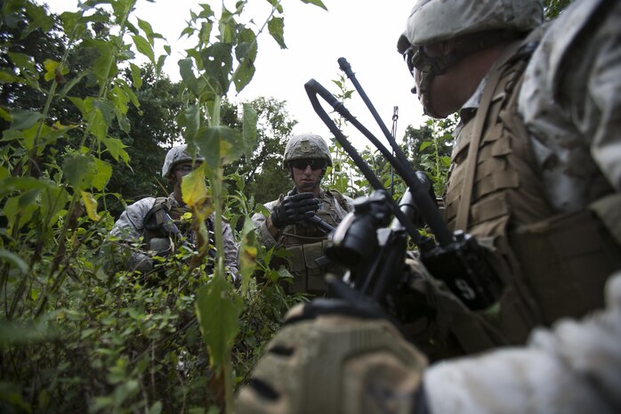 Lance Cpl. Timothy Blackburn (middle), Fleet Anti-Terrorism Support Team, Marine Corps Force Security Regiment instructs members of his squad on where they need to post security during convoy operations aboard Naval Expeditionary Combat Center, Naval Weapons Station Yorktown, Yorktown, Va., Aug. 31, 2016. The Marines conducted convoy operations to escort a role player acting as an ambassador. During the training the Marines had to post security to prevent opposing forces from executing a successful ambush and defeat the threat of improvised explosive devices. (Official U.S. Marine Corps photo by Sgt. Calvin Shamoon/ Released)