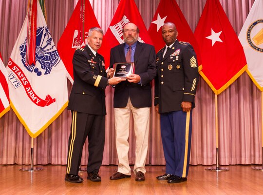 Steve Eggers, center, receives the Don Lawyer Award as the Corps of Engineers regulator of the year recipient from Lt. Gen. Todd T. Semonite, Chief of Engineers and U.S. Army Corps of Engineers commanding general, left, and Command Sgt. Maj. Antonio S. Jones during the 2016 National Awards Ceremony in Washington, D.C., Aug. 4.