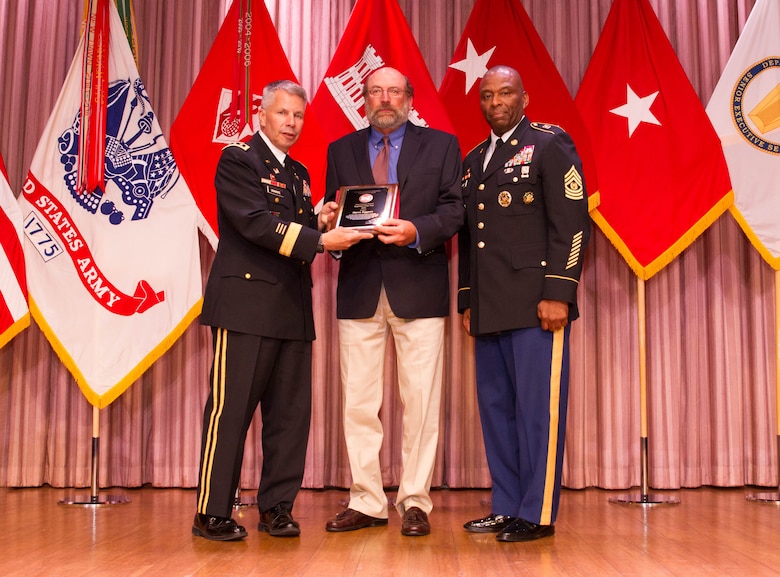 Steve Eggers, center, receives the Don Lawyer Award as the Corps of Engineers regulator of the year recipient from Lt. Gen. Todd T. Semonite, Chief of Engineers and U.S. Army Corps of Engineers commanding general, left, and Command Sgt. Maj. Antonio S. Jones during the 2016 National Awards Ceremony in Washington, D.C., Aug. 4.
