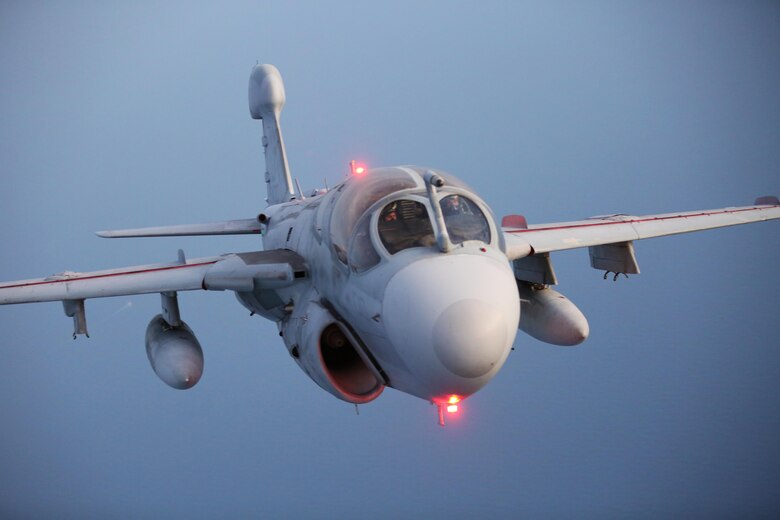 An EA-6B Prowler flies closely behind a KC-130J Super Hercules during an aerial refueling mission over the Atlantic Ocean Sept. 7, 2016. The mission of Marine Aerial Refueler Transport Squadron 252 is to support the Marine Air Ground Task Force commander by providing air-to-air refueling, assault support, and offensive air support, day or night under all weather conditions during expeditionary, joint, or combined operations.  VMGR-252 conducted aerial refuels for AV-8B Prowlers, EA-6B Harriers, and F-35B Lightnings off the coast of North Carolina to provide routine training for both the pilots and crew members. (U.S. Marine Corps Photo by Lance Cpl. Mackenzie Gibson/Released)