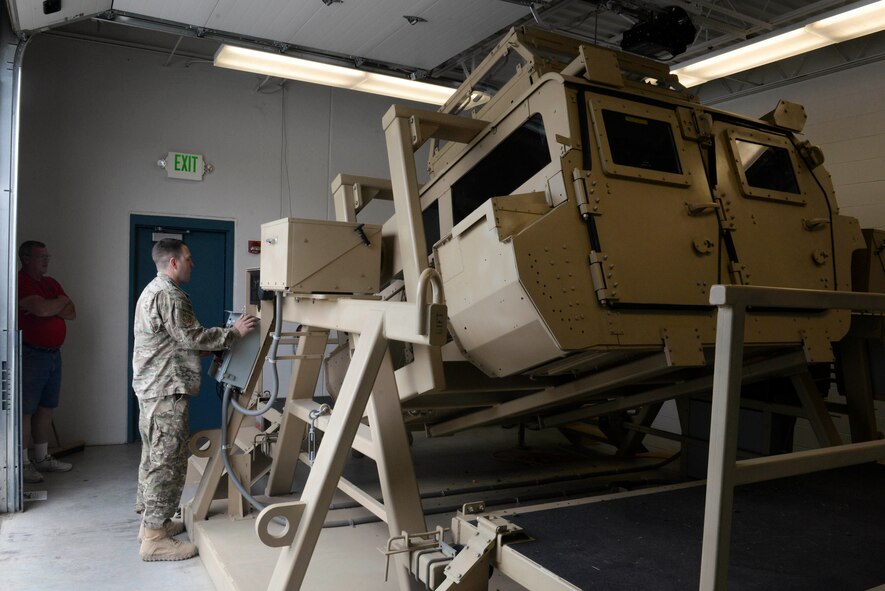 Senior Airman Daniel Connor, a security forces evaluator assigned to the 91st Security Forces Group, conducts Humvee rollover training at the Camp Grafton Training Center in Devils Lake, N.D., Sept. 7, 2016. The Humvee Egress Assistance Training teaches concepts and procedures, and increases survivability percentages for members involved in a roll-over accident. (U.S. Air Force photo/Airman 1st Class Jessica Weissman)
