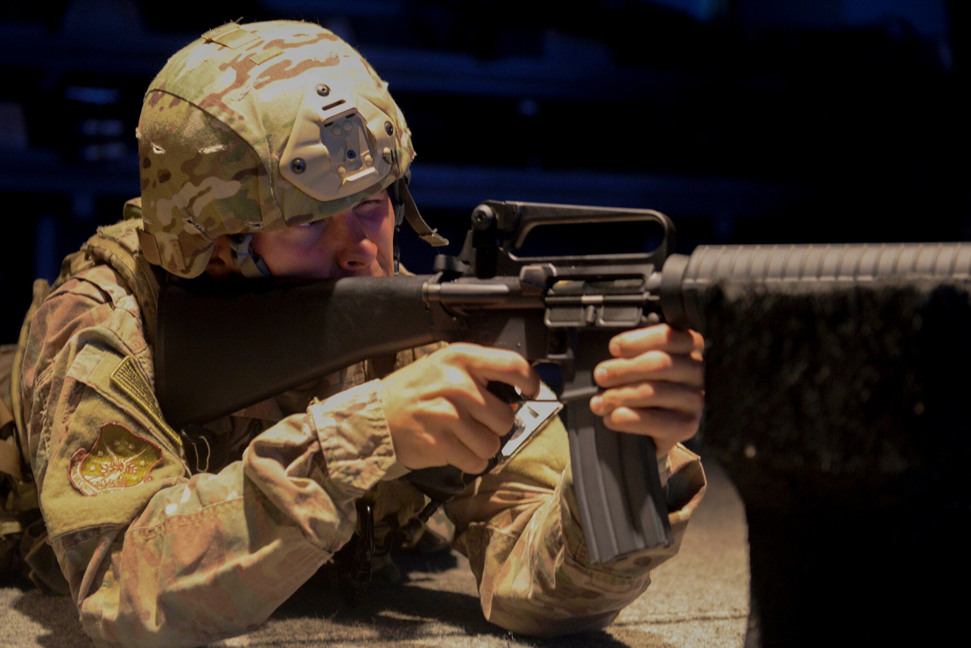 An Airman from the 91st Security Forces Group practices during a firearms training simulator at the Camp Grafton Training Center in Devils Lake, N.D., Sept. 7, 2016. The U.S. Army’s Engagement Skills Trainer allows Airmen to fire in a relaxed environment and focus on the fundamentals of firing.(U.S. Air Force photo/Airman 1st Class Jessica Weissman) 