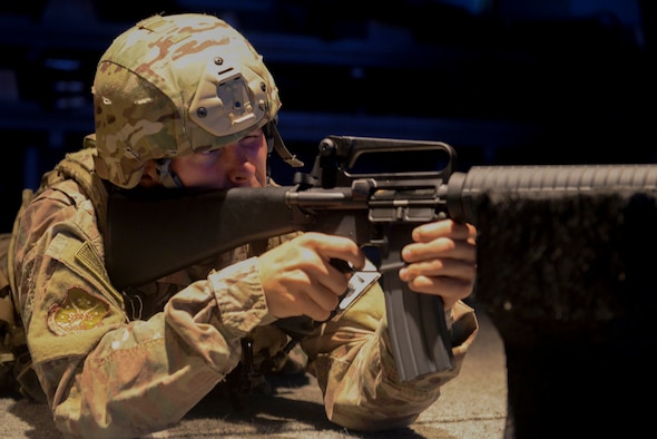 An Airman from the 91st Security Forces Group practices during a firearms training simulator at the Camp Grafton Training Center in Devils Lake, N.D., Sept. 7, 2016. The U.S. Army’s Engagement Skills Trainer allows Airmen to fire in a relaxed environment and focus on the fundamentals of firing.(U.S. Air Force photo/Airman 1st Class Jessica Weissman) 