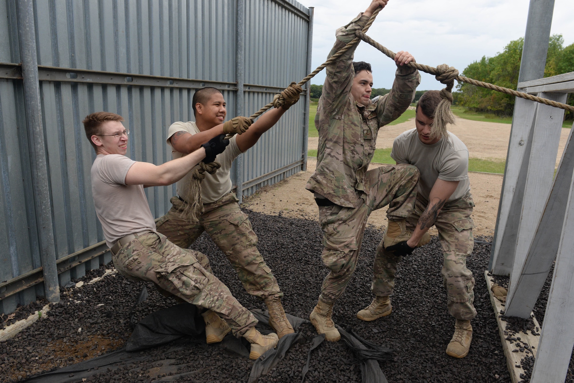 Airmen from the 91st Missile Security Forces Squadron maneuver through an obstacle at the Camp Grafton Training Center in Devils Lake, N.D., Sept. 7, 2016. This obstacle course increased leadership skills and communication throughout the unit. (U.S. Air Force photo/Airman 1st Class Jessica Weissman)