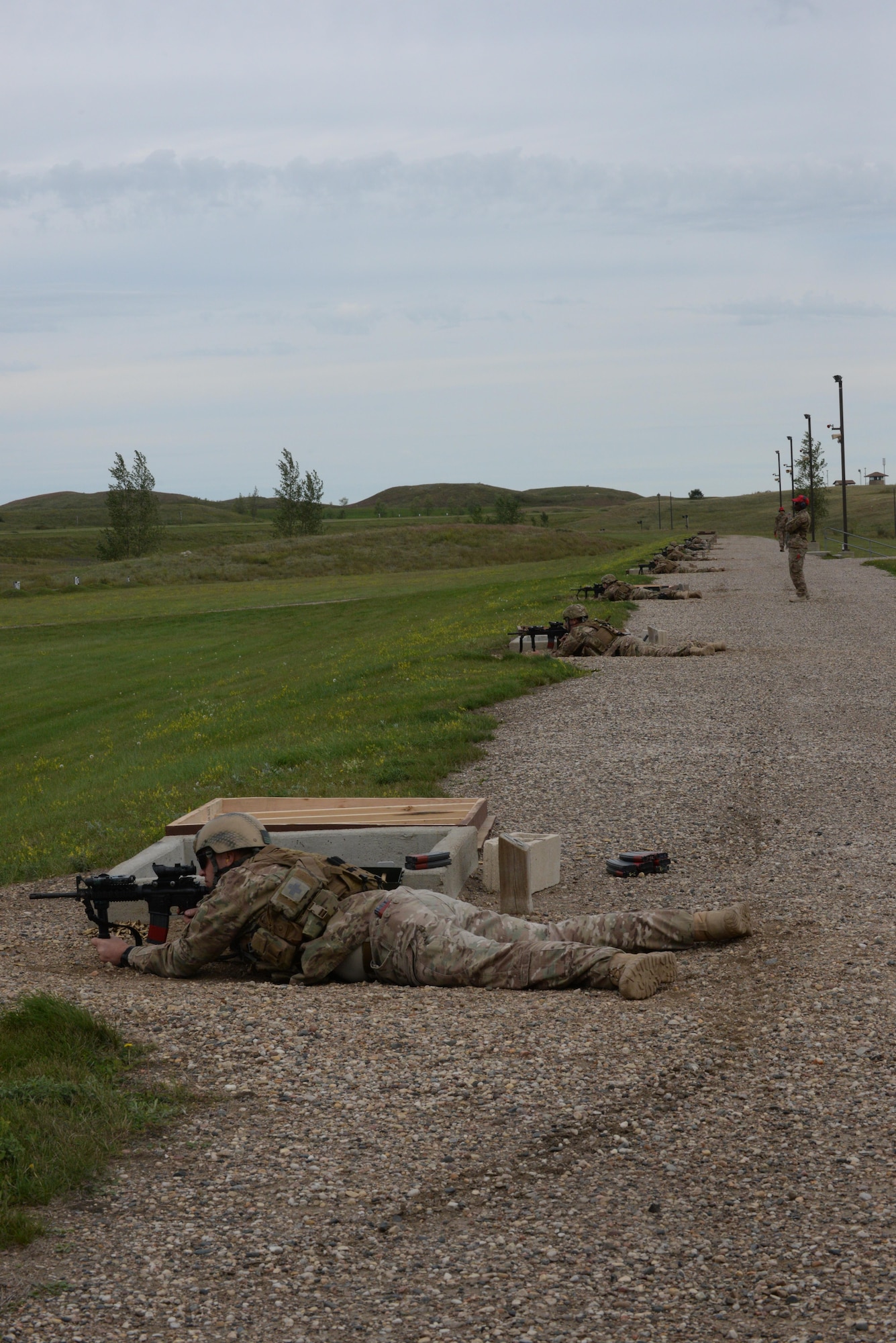 Airmen from the 91st Missile Security Forces Squadron fire their M4 at a weapons training range at the Camp Grafton Training Center in Devils Lake, N.D., Sept. 7, 2016. Airmen were able to shoot pop-up targets from 50-300 m to replicate real-life distances. (U.S. Air Force photo/Airman 1st Class Jessica Weissman)