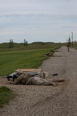 Airmen from the 91st Missile Security Forces Squadron fire their M4 at a weapons training range at the Camp Grafton Training Center in Devils Lake, N.D., Sept. 7, 2016. Airmen were able to shoot pop-up targets from 50-300 m to replicate real-life distances. (U.S. Air Force photo/Airman 1st Class Jessica Weissman)