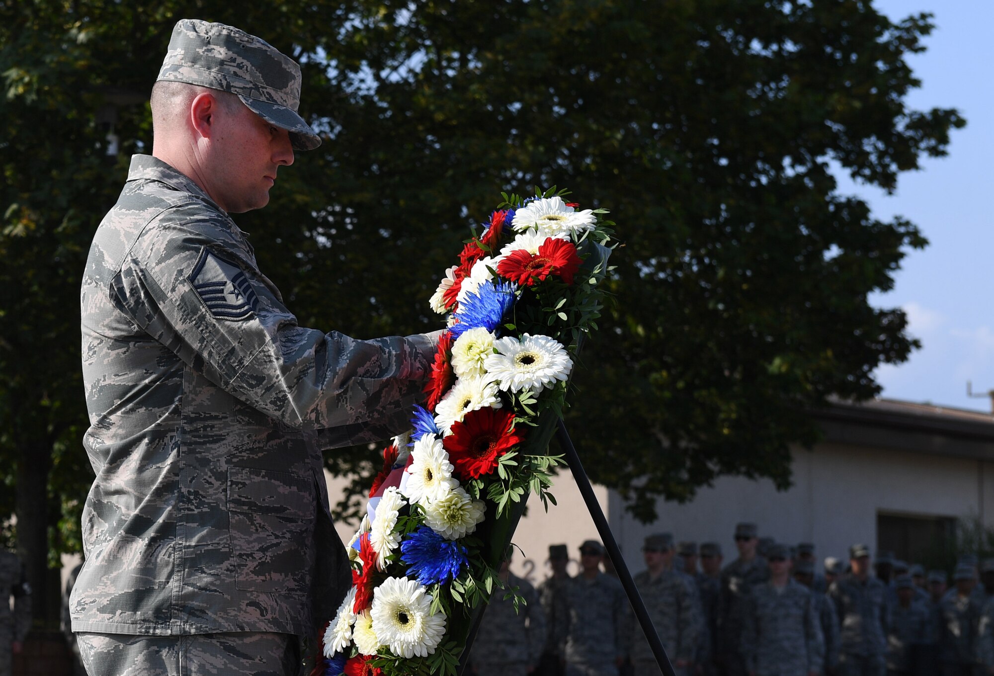 Master Sgt. Jesse Burkard, 86th Civil Engineer Squadron fire protection superintendent, lays a wreath during a 9/11 Memorial Retreat Ceremony Sept. 9, 2016 at Ramstein Air Base, Germany. 2,977 people lost their lives and over 6,000 were injured during the attacks, resulting in one of the largest domestic terrorist attacks in U.S. history. (U.S. Air Force photo/Senior Airman Tryphena Mayhugh) 
