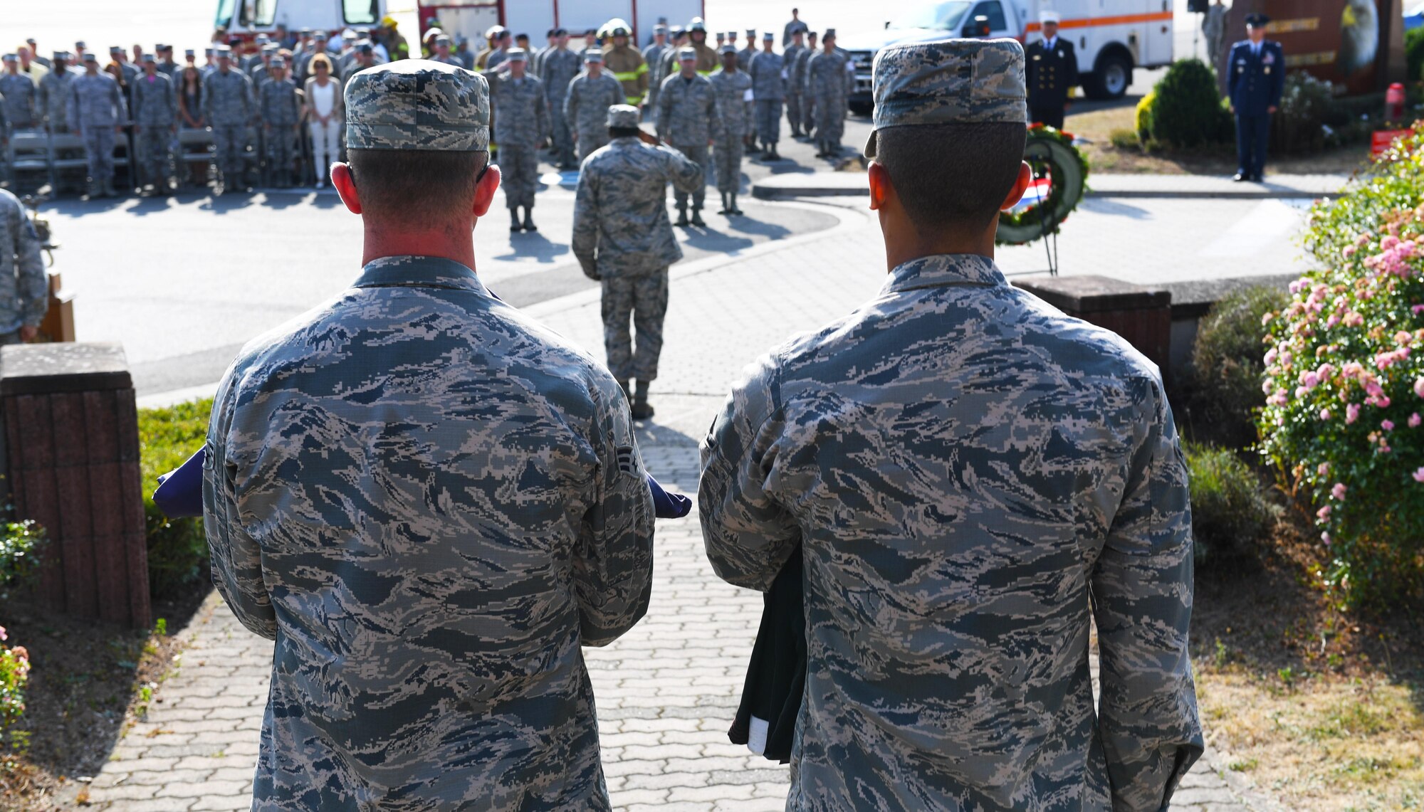 Two 86th Airlift Wing Airmen hold a folded American and German flag during a 9/11 Memorial Retreat Ceremony Sept. 9, 2016 at Ramstein Air Base, Germany. 2,977 people lost their lives and over 6,000 were injured during the attacks, resulting in one of the largest domestic terrorist attacks in U.S. history. (U.S. Air Force photo/Senior Airman Tryphena Mayhugh)