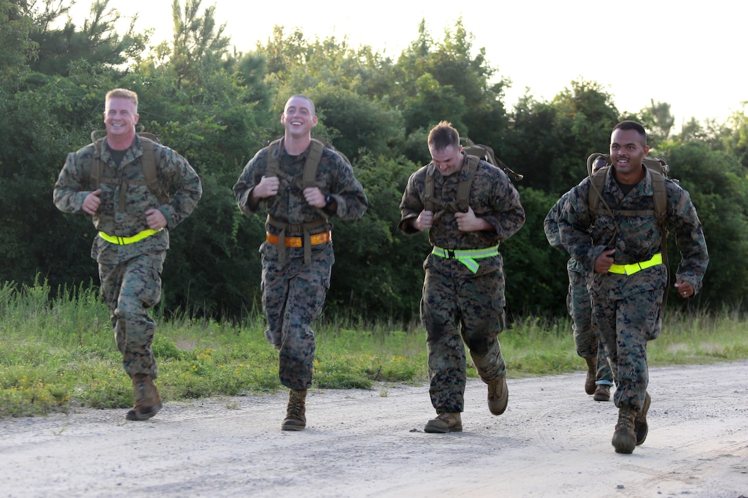 Marines assigned to Marine Tactical Air Command Squadron 28 run to their next station during their second annual Warrior Day at Marine Corps Air Station Cherry Point, N.C., Sept. 1, 2016. More than 50 Marines participated in MTACS-28's warrior day which included six different stations that incorporated ground fighting matches, an M-16 service rifle disassembly and reassembly, kayaking, radio set-up, repelling, and a 50-yard Humvee pull. Marines worked hand-in-hand to complete events as a team while sharing diverse leadership styles, years of experience and espirit de Corps. MTACS-28 is part of Marine Air Control Group 28, 2nd Marine Aircraft Wing. (U.S. Marine Corps photo by Cpl. Jason Jimenez/Released)
