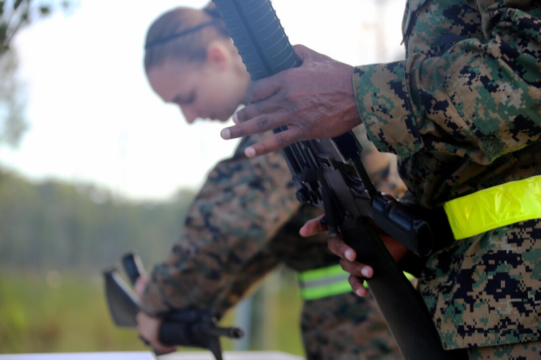 Marines assigned to Marine Tactical Air Command Squadron 28 disassemble and reassemble an M-16 service rifle during their second annual Warrior Day at Marine Corps Air Station Cherry Point, N.C., Sept. 1, 2016. More than 50 Marines participated in MTACS-28's warrior day which included six different stations that incorporated ground fighting matches, an M-16 service rifle disassembly and reassembly, kayaking, radio set-up, repelling, and a 50-yard Humvee pull. Marines worked hand-in-hand to complete events as a team while sharing diverse leadership styles, years of experience and espirit de Corps. MTACS-28 is part of Marine Air Control Group 28, 2nd Marine Aircraft Wing. (U.S. Marine Corps photo by Cpl. Jason Jimenez/Released)