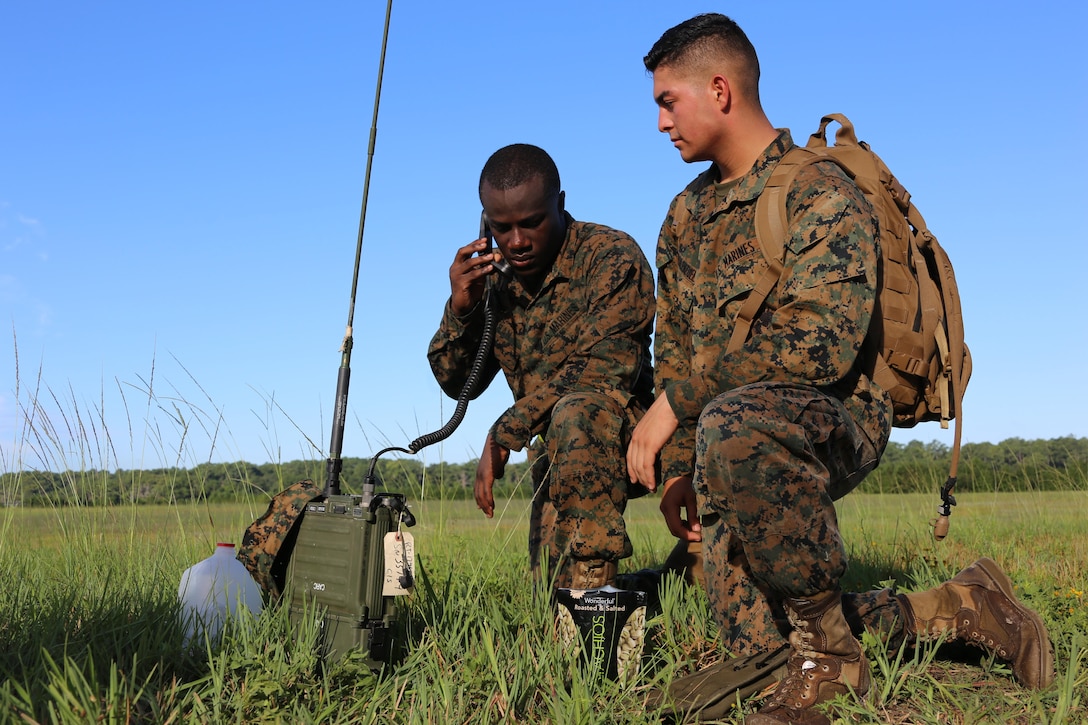 Cpl. Patrick Dean, left, and Pfc. Juan Diaz-Valenzuela conduct a radio check during Marine Tactical Air Command Squadron 28’s second annual Warrior Day at Marine Corps Air Station Cherry Point, N.C., Sept. 1, 2016. More than 50 Marines participated in MTACS-28's warrior day which included six different stations that incorporated ground fighting matches, an M-16 service rifle disassembly and reassembly, kayaking, radio set-up, repelling, and a 50-yard Humvee pull. Marines worked hand-in-hand to complete events as a team while sharing diverse leadership styles, years of experience and espirit de Corps. MTACS-28 is part of Marine Air Control Group 28, 2nd Marine Aircraft Wing. (U.S. Marine Corps photo by Cpl. Jason Jimenez/Released)