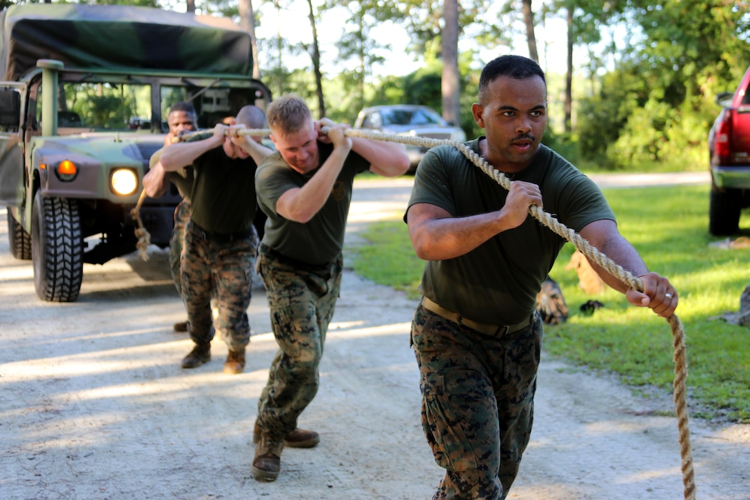 Marines assigned to Marine Tactical Air Command Squadron 28 pull a Humvee during their second annual Warrior Day at Marine Corps Air Station Cherry Point, N.C., Sept. 1, 2016. More than 50 Marines participated in MTACS-28's warrior day which included six different stations that incorporated ground fighting matches, an M-16 service rifle disassembly and reassembly, kayaking, radio set-up, repelling, and a 50-yard Humvee pull. Marines worked hand-in-hand to complete events as a team while sharing diverse leadership styles, years of experience and espirit de Corps. MTACS-28 is part of Marine Air Control Group 28, 2nd Marine Aircraft Wing. (U.S. Marine Corps photo by Cpl. Jason Jimenez/Released)