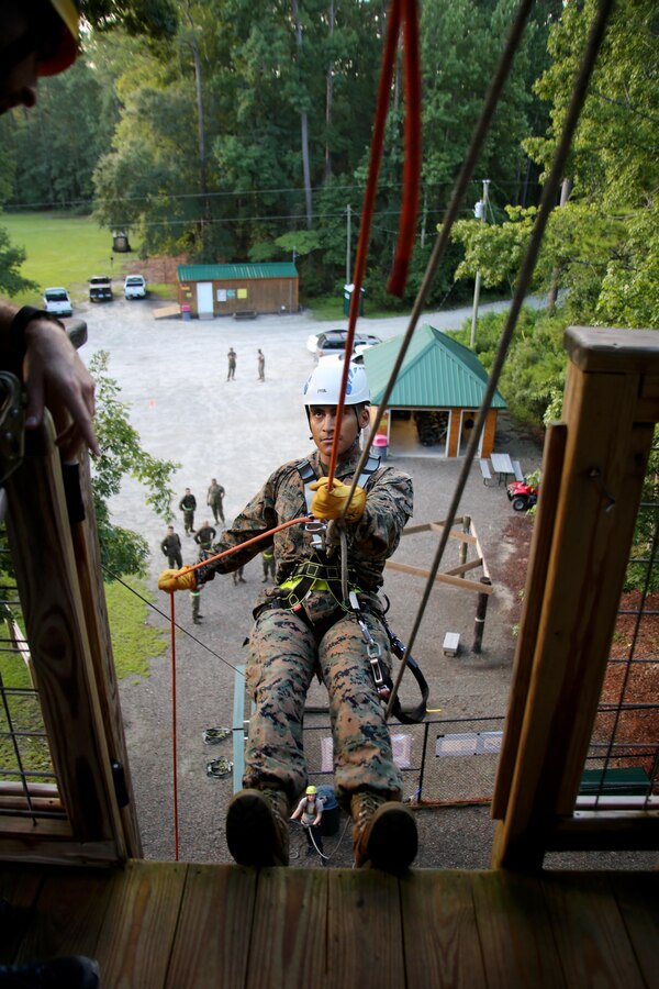 Sgt. Jaime Garcia repels during Marine Tactical Air Command Squadron 28 second annual Warrior Day at Marine Corps Air Station Cherry Point, N.C., Sept. 1, 2016. More than 50 Marines participated in MTACS-28's warrior day which included six different stations that incorporated ground fighting matches, an M-16 service rifle disassembly and reassembly, kayaking, radio set-up, repelling, and a 50-yard Humvee pull. Marines worked hand-in-hand to complete events as a team while sharing diverse leadership styles, years of experience and espirit de Corps. MTACS-28 is part of Marine Air Control Group 28, 2nd Marine Aircraft Wing. (U.S. Marine Corps photo by Cpl. Jason Jimenez/Released)