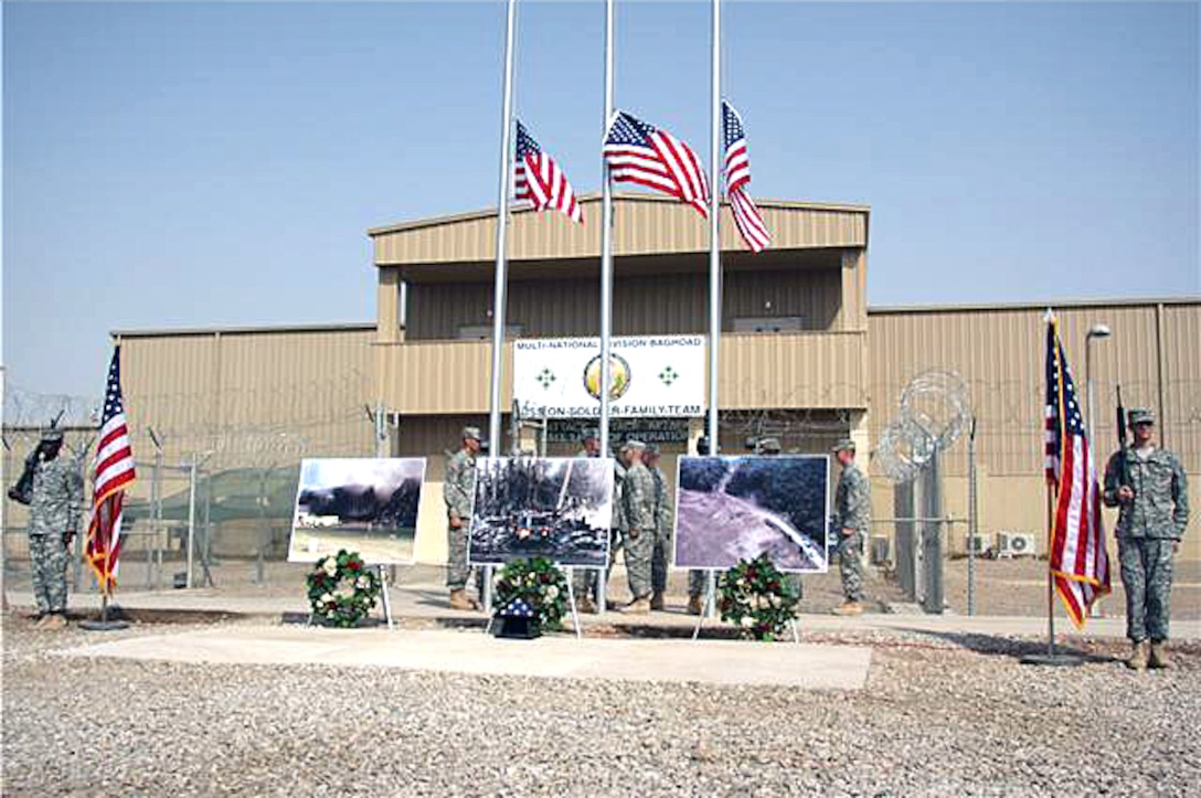 Soldiers lower three American flags to half-staff during a 9/11 memorial service at Camp Liberty, Iraq, Sept. 11, 2008. The soldiers were assigned to the 4th Infantry Division, Multinational Division Baghdad. Army photo by Pfc. Lyndsey Dransfield   