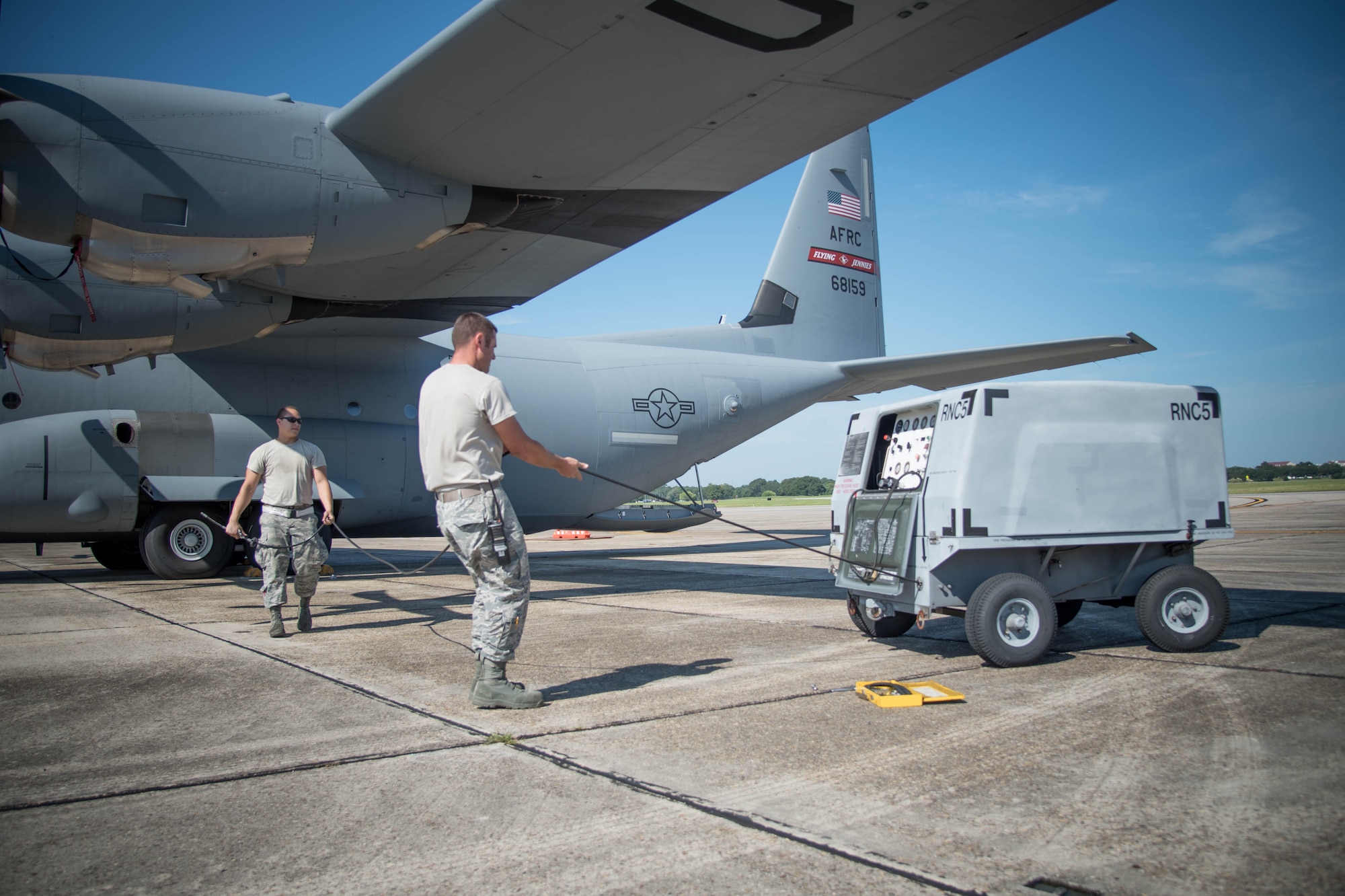 Senior Airman Kevin Minnick,403rd Maintenance Squadron aircraft maintainer and Master Sgt. Jonathan McCarty, 403rd AMXS crew chief, prepare to service tires on one of the 815th Airlift Squadron's C-130J Super Hercules aircraft. The 403rd Wing will be gaining the new 803rd Aircraft Maintenance Squadron during an activation ceremony Sept. 11. (U.S. Air Force photo/Senior Airman Heather Heiney) 