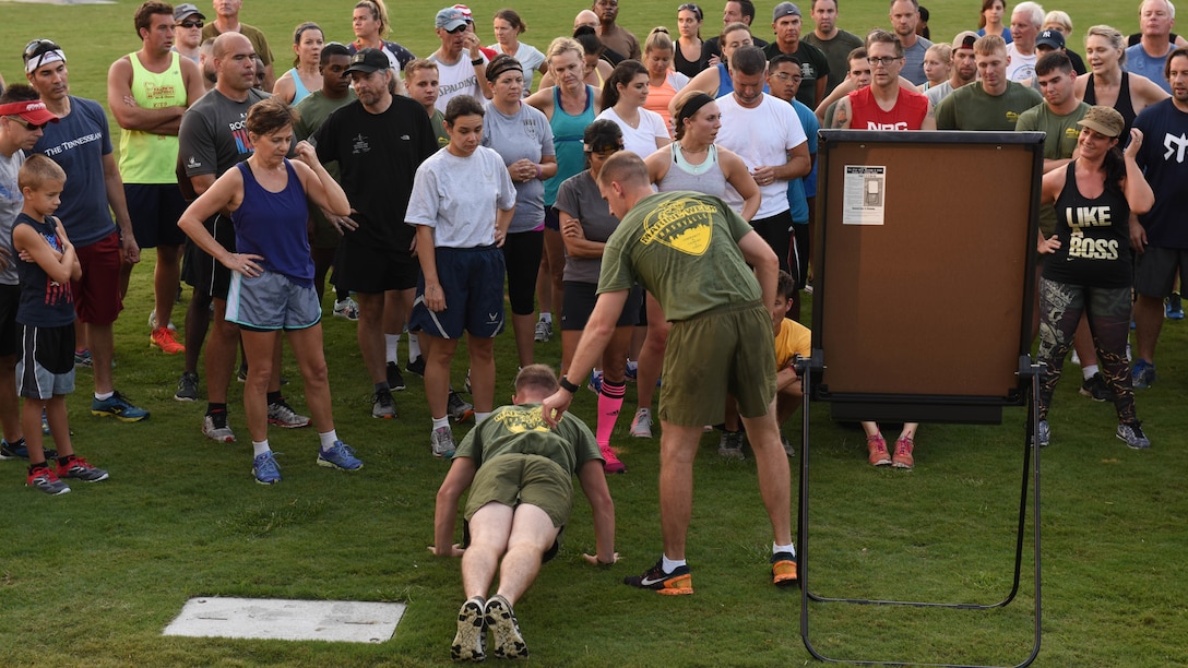 1st Lt. Edward Bennett, S-4 Alpha with Headquarters and Service Company, 2nd Battalion, 6th Marines, shows how to do a proper push-up during the public physical training event, Sept. 8, 2016, at the Walk of Fame Park in downtown Nashville as part of Marine Week. This event was one of many events hosted during Marine Week to help promote a greater relationship between the community and the Marine Corps.