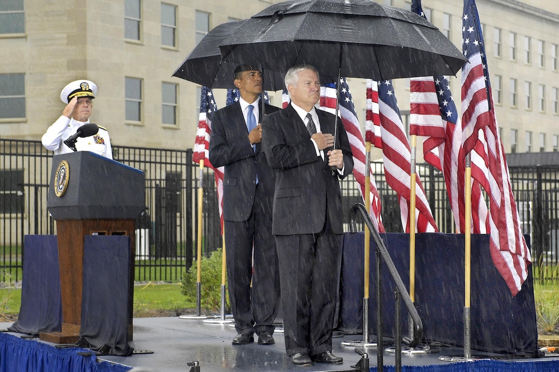 President Barack Obama, center, Defense Secretary Robert M. Gates, right, and Navy Adm. Mike Mullen, chairman of the Joint Chiefs of Staff, salute under rainy skies during a wreath-laying ceremony during the 9/11 remembrance ceremony at the Pentagon Memorial, Sept. 11, 2009. DoD photo by Robert Ward    