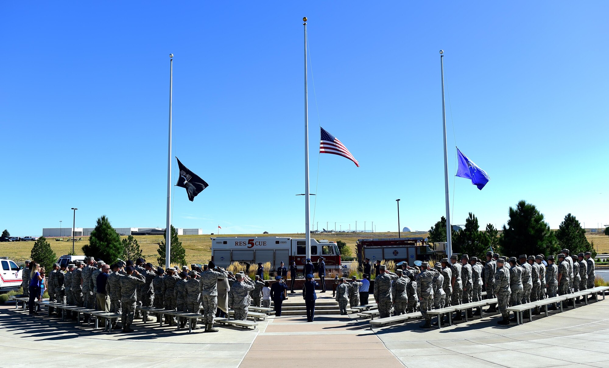 Team Buckley members salute as the national anthem is played during a during a Patriot Day ceremony Sept. 9, 2016, on Buckley Air Force Base, Colo. Patriot Day provides the United States a day of reflecting on the lives lost and paying tribute to the families still recovering from their loss on Sept. 11, 2001. (U.S. Air Force photo by Airman 1st Class Gabrielle Spradling/Released)