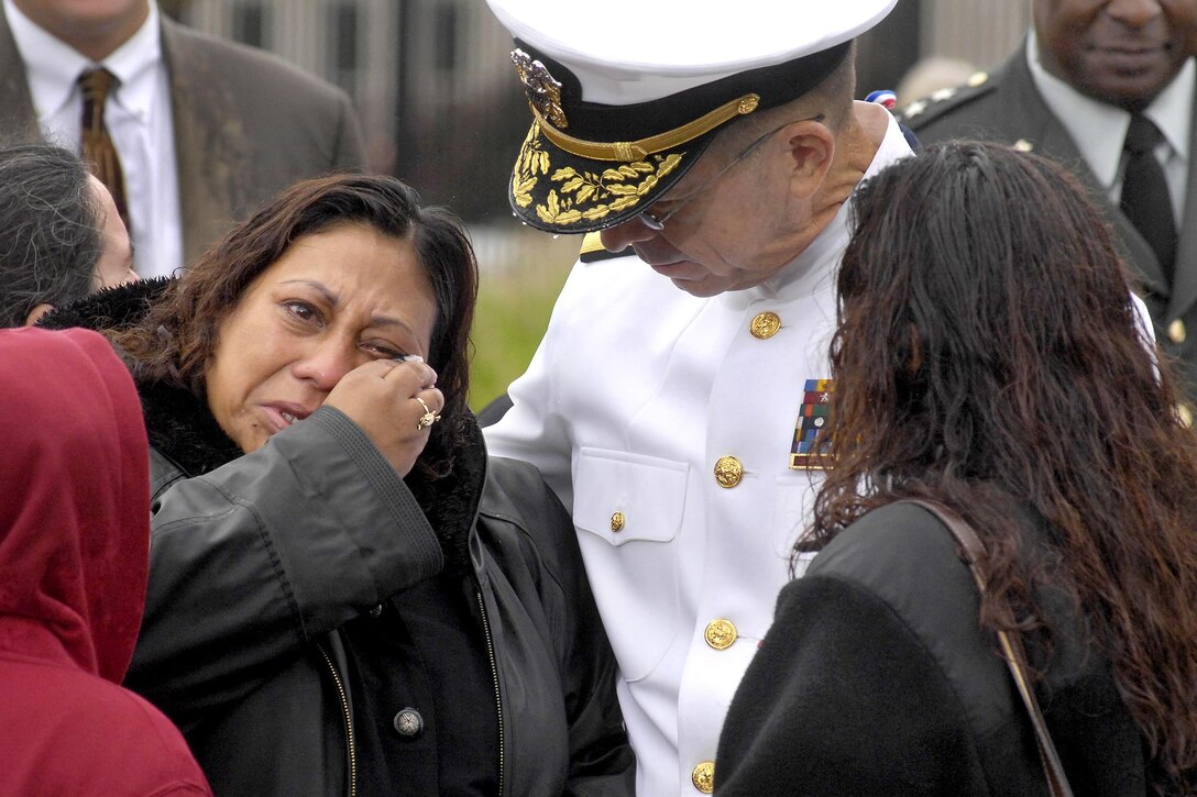 Navy Adm. Mike Mullen, chairman of the Joint Chiefs of Staff, comforts a family member after the 9/11 commemoration ceremony at the Pentagon Memorial, Sept. 11, 2009. DoD photo by Robert Ward