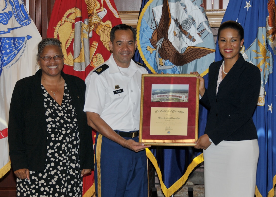 DLA Chief of Staff Renee Roman and Army Command Sgt. Maj. Charles Tobin present Michelle Millben a token of appreciation for her speech during DLA’s Resiliency Day Sept. 7.