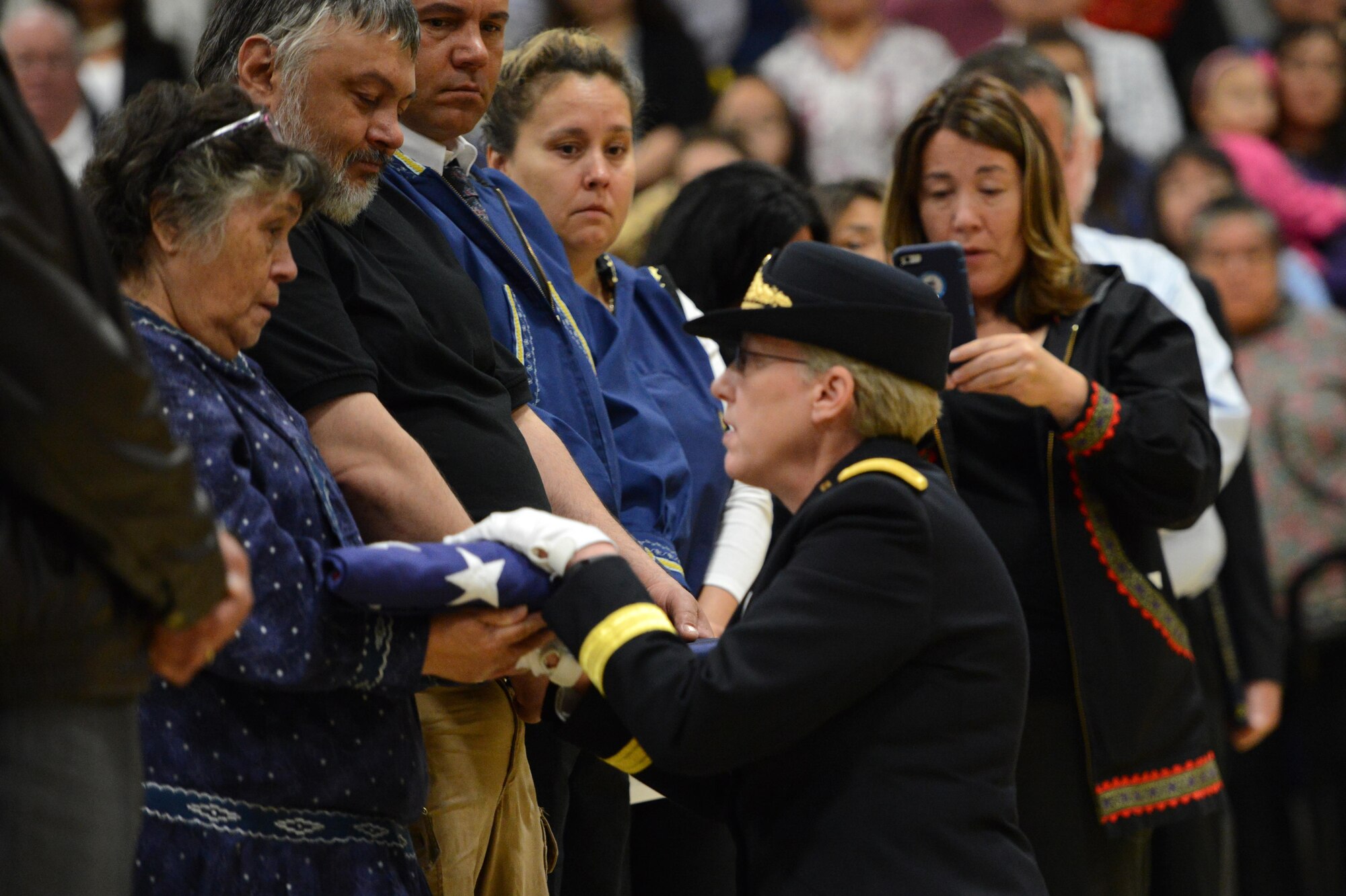 Brig. Gen. Laurie Hummel, Alaska National Guard adjutant general, presents a folded American flag to Mary Schaeffer, wife of former Alaska Adjutant General Maj. Gen. John Schaeffer Jr, during the late general’s memorial service at Kotzebue, Alaska, Aug. 31, 2016. Schaeffer enlisted in the Alaska National Guard in 1957, and served for 34 years.  Schaeffer was the first Alaska Native two-star general of the Alaska National Guard and commissioner of the Alaska Department of Military and Veterans Affairs. He is survived by Mary his wife of 56 years. (U.S. Air Force photo by Airman 1st Class Javier Alvarez)