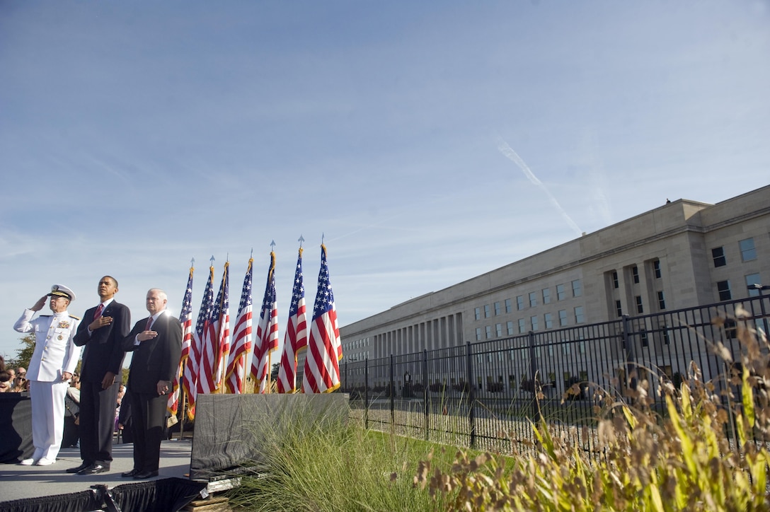 Navy Adm. Mike Mullen, left, chairman of the Joint Chiefs of Staff, President Barack Obama and Defense Secretary Robert M. Gates salute during the playing of the national anthem at the Pentagon Memorial during a Sept. 11, 2010, ceremony marking the ninth anniversary of the 9/11 terrorist attacks. DoD photo by Cherie Cullen