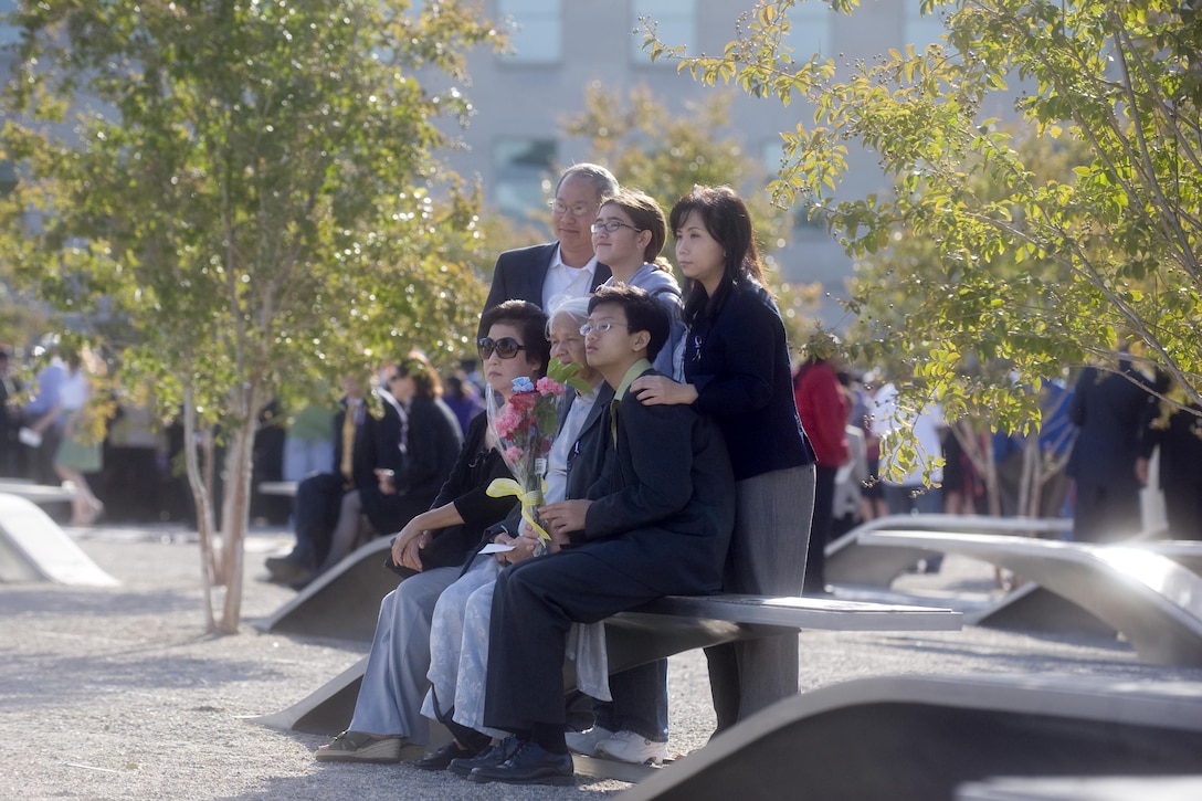 Family members sit on a memorial bench commemorating a loved one who died in the Pentagon during the 9/11 terrorist attack, following a ceremony at the Pentagon Memorial marking the ninth anniversary of the attack, Sept. 11, 2010. DoD photo by Cherie Cullen