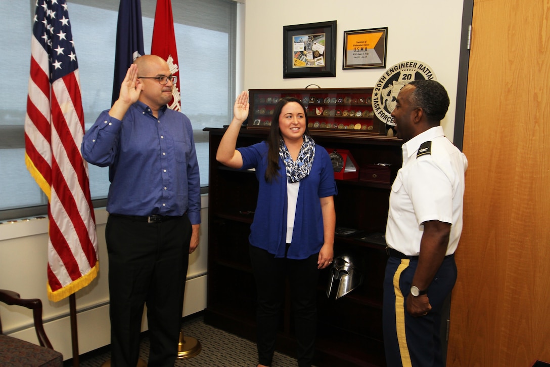 Norberto Quinones, a pathways intern from Binghamton University,  and Brittany Dunn, a pathways intern from Christopher Newport University, are sworn into federal service by Col. Jason Kelly, Norfolk District commander in his office in Norfolk, Virginia. The Pathways program offers three types of internship opportunities to individuals who are just starting out in their potential federal careers: the Internship Program, Recent Graduates Program and Presidential Management Fellows Program. (U.S. Army photo/Patrick Bloodgood)