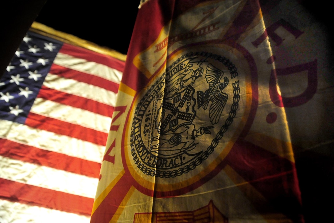 The U.S. and Fire Department of New York flags hang on the 9/11 memorial at Forward Operating Base Farah, Afghanistan, Sept. 11, 2010.  Air Force photo by Senior Airman Rylan Albright