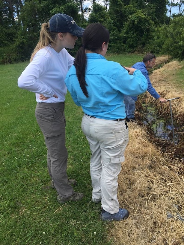 Carly Golden (left), a pathways intern from Brandeis University, an Brittany Dunn, a pathways intern from Christopher Newport University, discuss their observations during a field visit for a jurisdictional determination in Northampton County, Va.  The Pathways program offers three types of internship opportunities to individuals who are just starting out in their potential federal careers: the Internship Program, Recent Graduates Program and Presidential Management Fellows Program