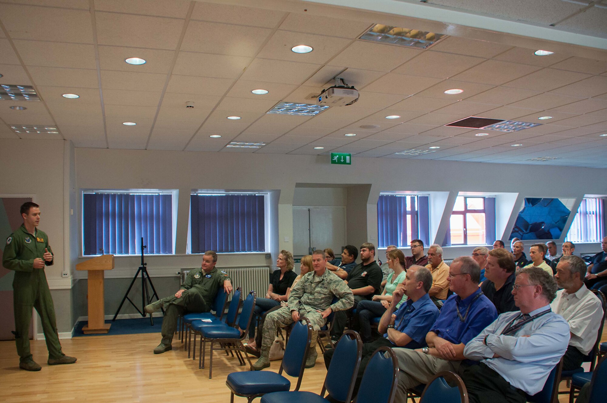 U.S. Air Force Capt. James Bresnahan, B-52H Stratofortress pilot, briefs a group of personnel from Royal Air Force Fairford and members of leadership from the town of Fairford, during a base and local community lunch event Sept. 6, 2016 at RAF Fairford, England.  Bresnahan is assigned to the 11th Bomb Squadron, Barksdale AFB, La. and deployed to RAF Fairford to participate in Exercise Ample Strike, a Czech Republic led, 18 nation live exercise.  (U.S. Air Force photo by 1st Lt. Monique Roux/Released)