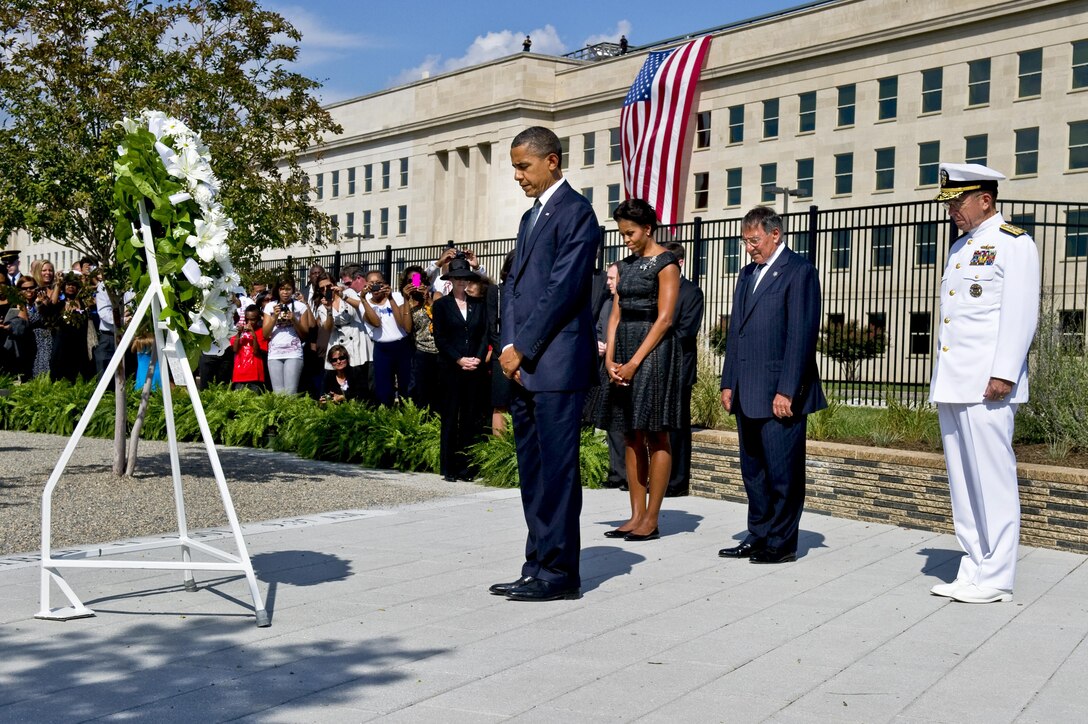 President Barack Obama pauses for a moment of silence after laying a wreath at the Pentagon Memorial, Sept. 11, 2011, with First Lady Michelle Obama, Defense Secretary Leon E. Panetta and Navy Adm. Mike Mullen, chairman of the Joint Chiefs of Staff, to honor the 184 people killed when American Airlines Flight 77 crashed into the Pentagon during a terrorist attack 10 years ago. DOD photo by Navy Petty Officer 1st Class Chad J. McNeeley    
